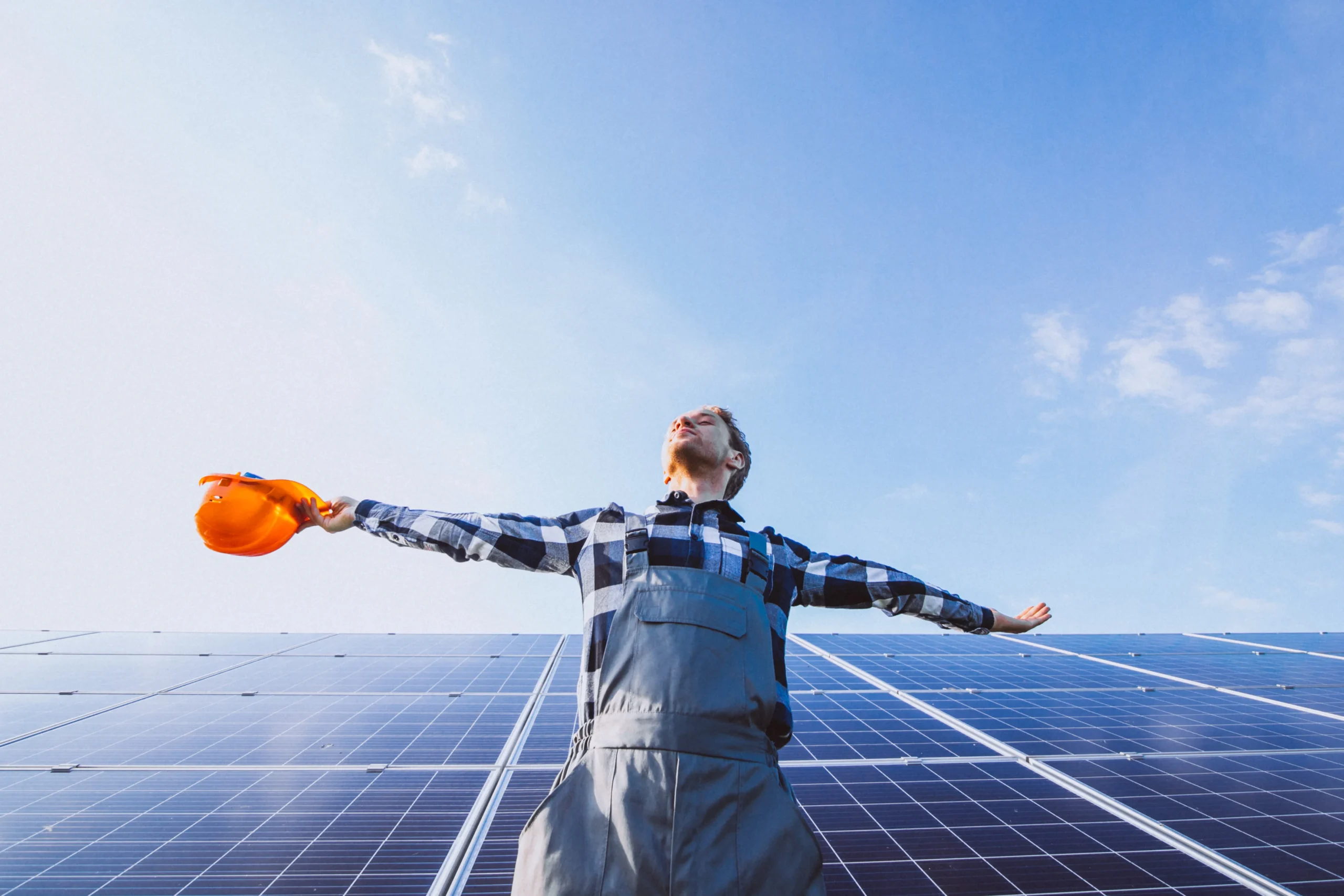 man worker firld by solar panels